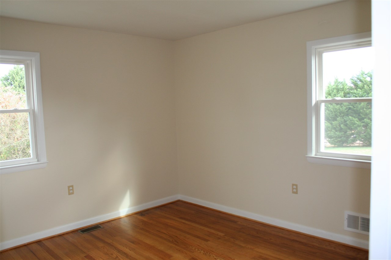 209 Oak Park Road Madison, VA 22727 - Photo 13 of 20 an empty room with wooden floor and windows