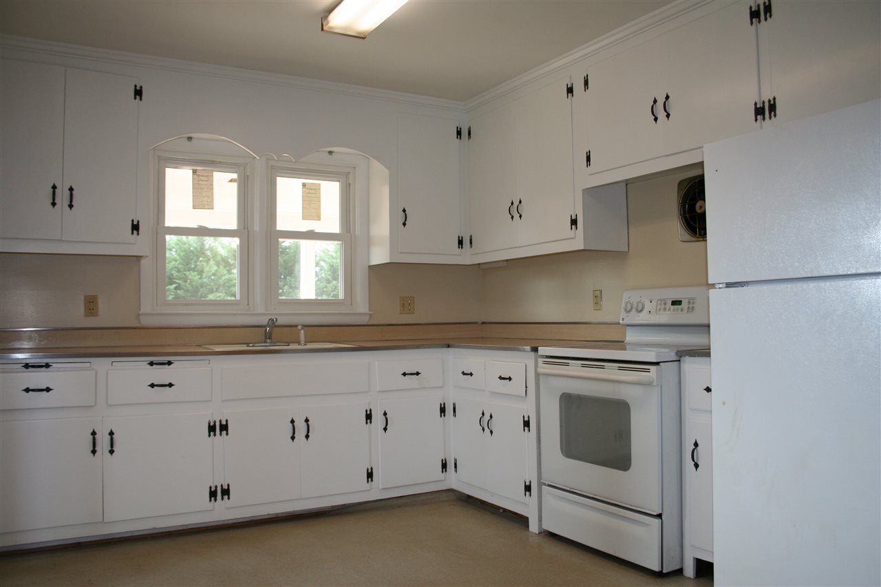 209 Oak Park Road Madison, VA 22727 - Photo 10 of 20 a kitchen with white cabinets white stainless steel appliances and sink