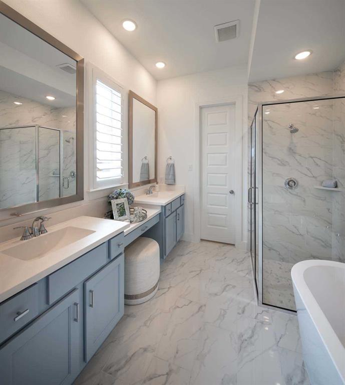 a large bathroom with a granite countertop sink mirror and shower