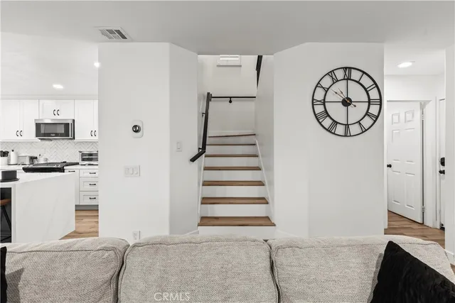 a kitchen with stainless steel appliances kitchen island granite countertop a dining table and chairs