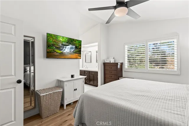 a bedroom with a bed and a tv