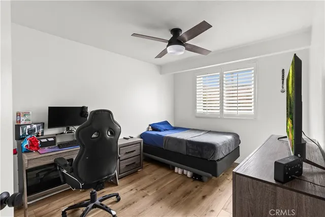 a bedroom with a bed and wooden floor