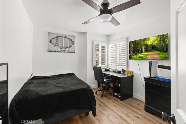 a view of a workspace with furniture and wooden floor