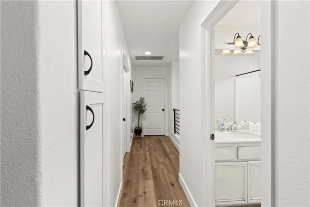 a bathroom with a sink vanity mirror and toilet