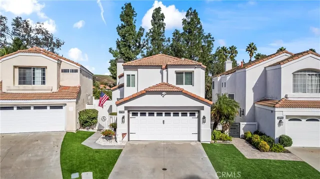 a front view of a house with a garden and plants
