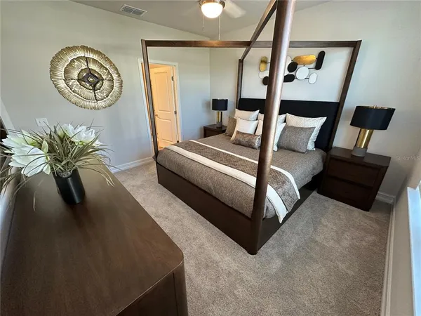 a bedroom with a bed and a chandelier