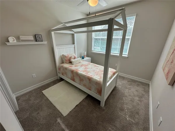 a bedroom with a bed and window
