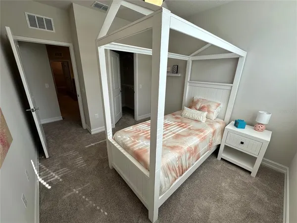 a bed room with a bed and a window
