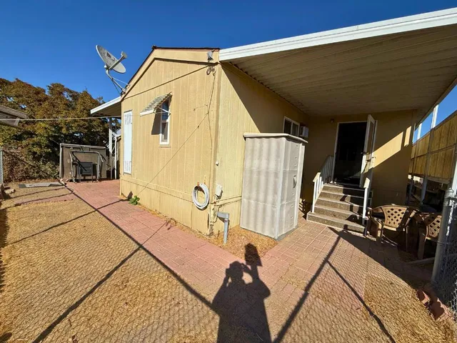 a view of a house with a backyard