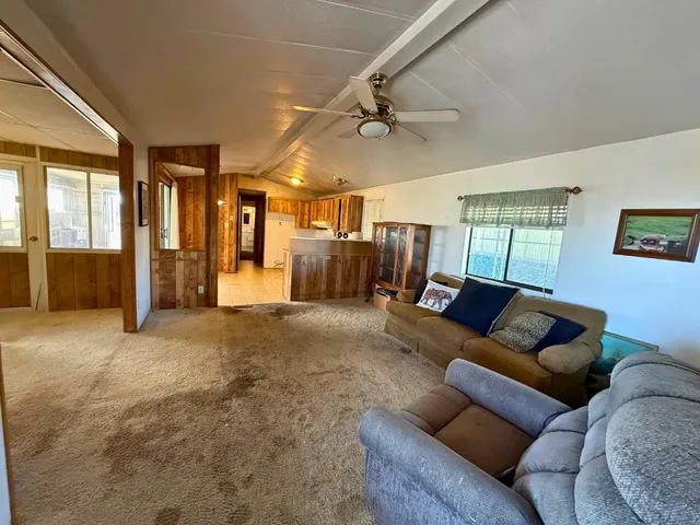 a living room with furniture and a ceiling fan