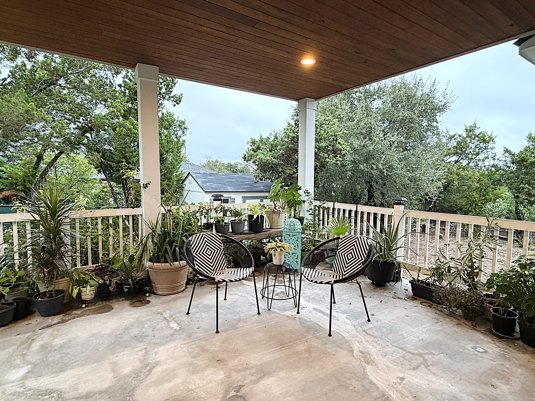 20602 Oak Ridge Lago Vista, TX 78645 - Photo 28 of 35 A handsome wood-paneled ceiling shelters this concrete patio overlooking mature trees.