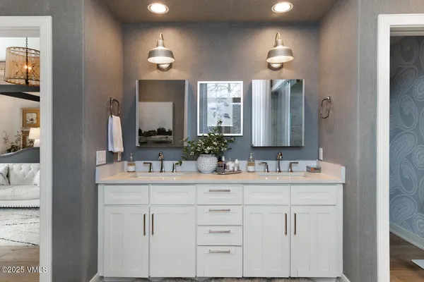 a bathroom with a sink a toilet a mirror and shower