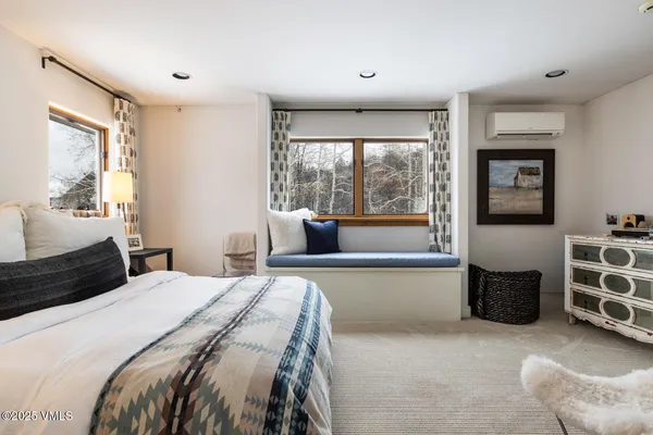 a view of a bedroom with a bed and flat screen tv
