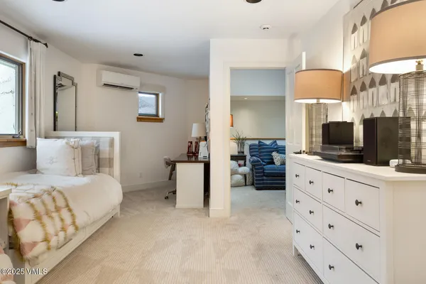 a bedroom with two beds and a dresser