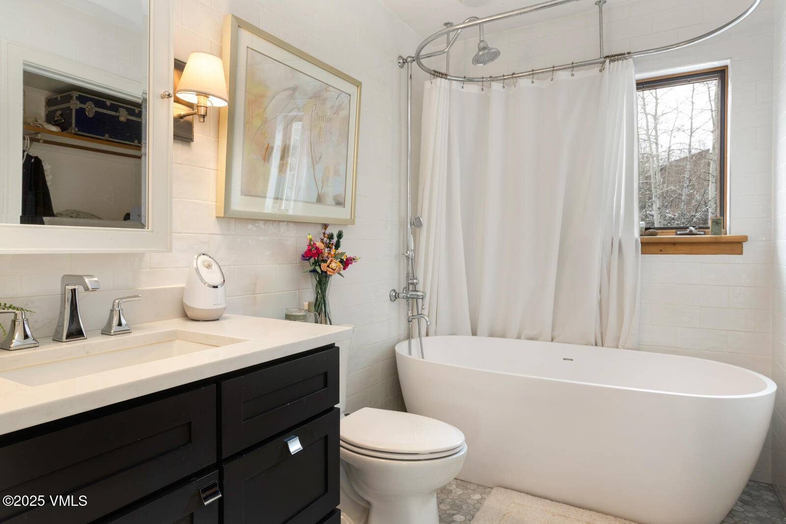 55 Elk Place Edwards, CO 81632 - Photo 38 of 68 a bathroom with a sink a toilet a mirror a bathtub and shower