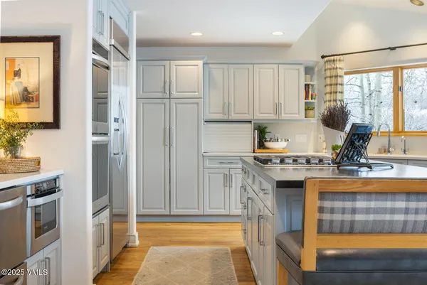 a kitchen with granite countertop a sink window and cabinets
