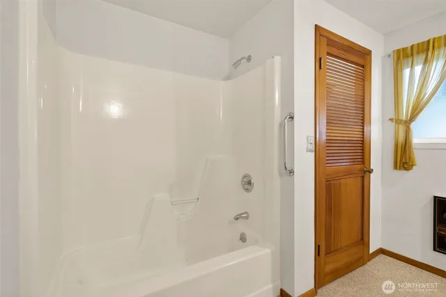 a bathroom with a bathtub and shower