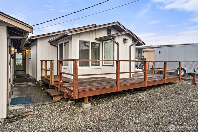 a view of a house with a small yard and wooden fence