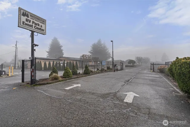 a gym room with lots of furniture and chandelier