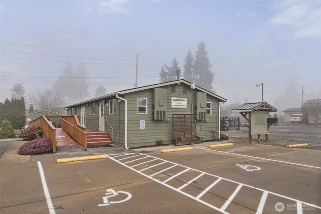 a outdoor space with lots of chairs a dining table and a chandelier