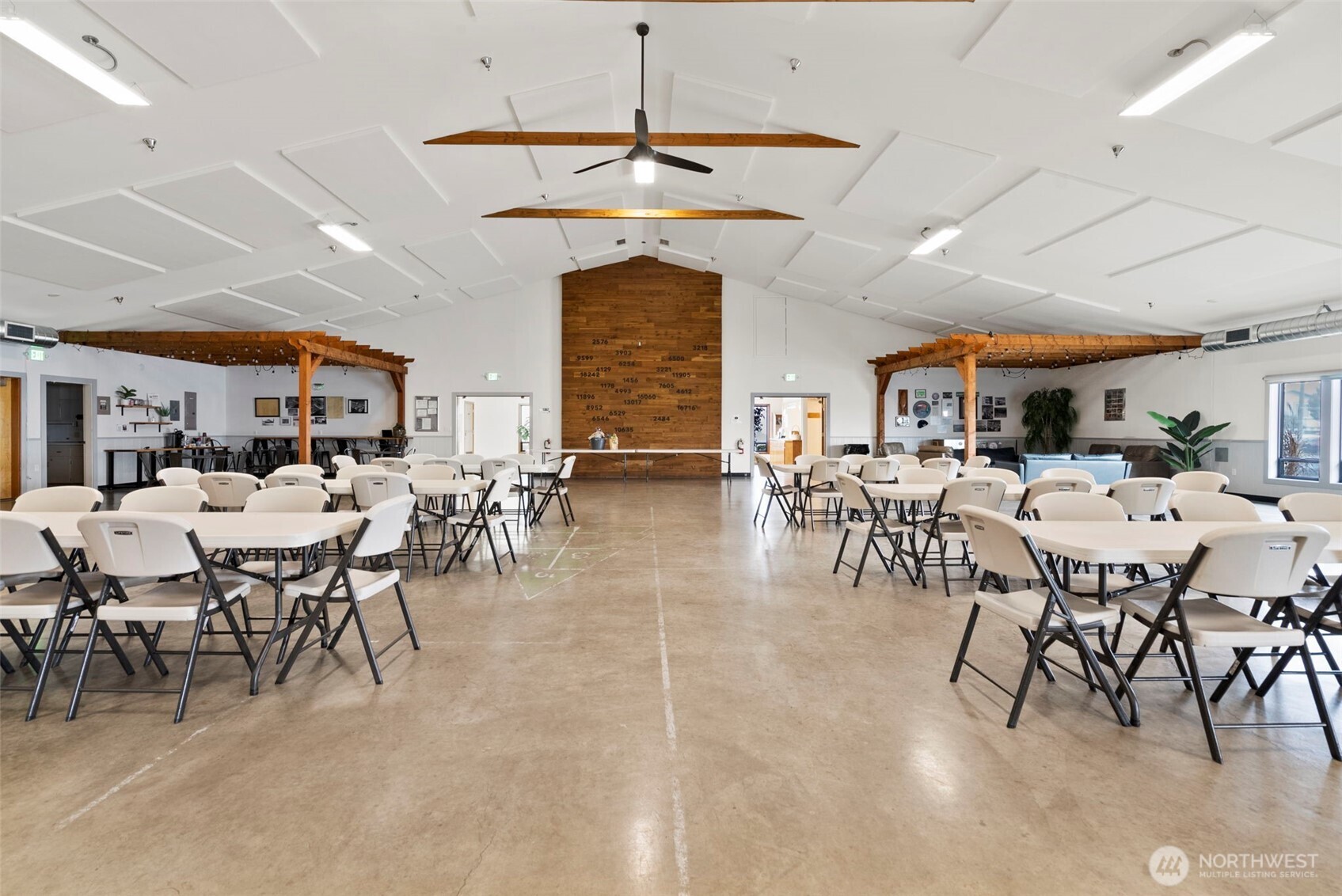 9101 Steilacoom Road Southeast, Unit 93 Olympia, WA 98513 - Photo 36 of 40 a outdoor space with lots of chairs a dining table and a chandelier