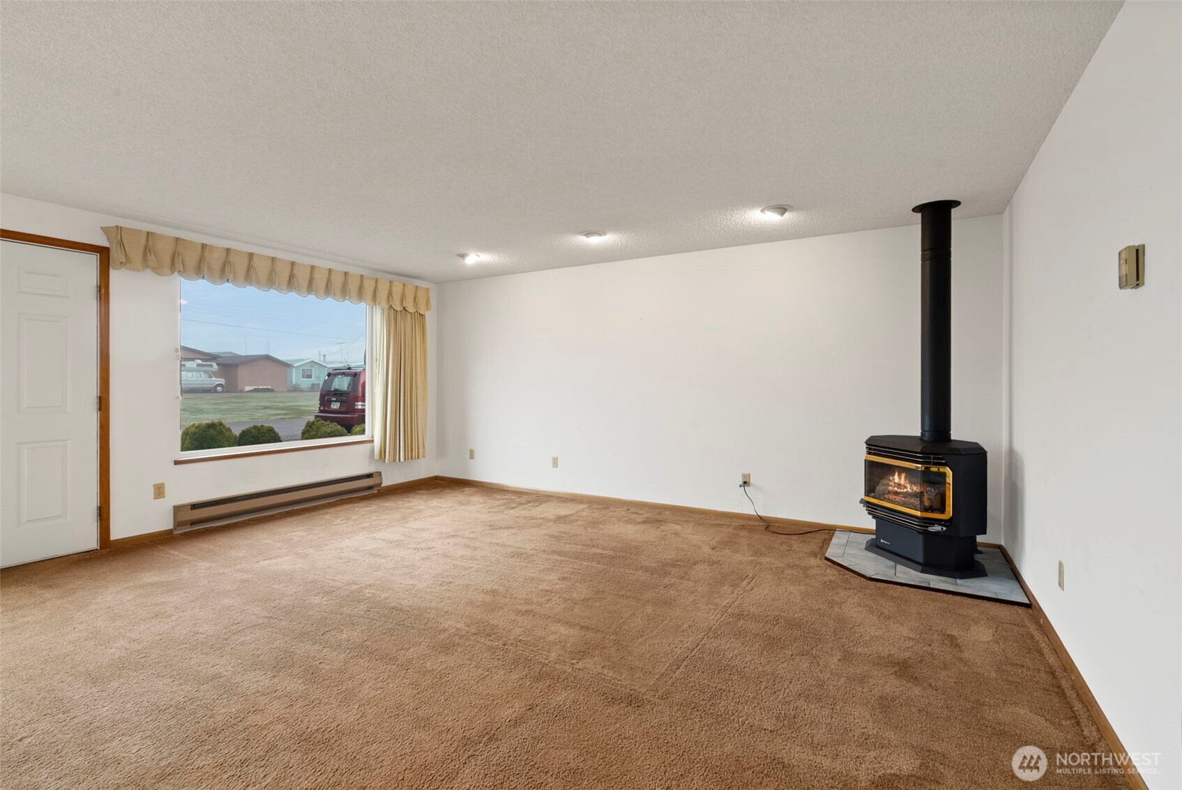 9101 Steilacoom Road Southeast, Unit 93 Olympia, WA 98513 - Photo 5 of 40 a view of an empty room with painting on the wall