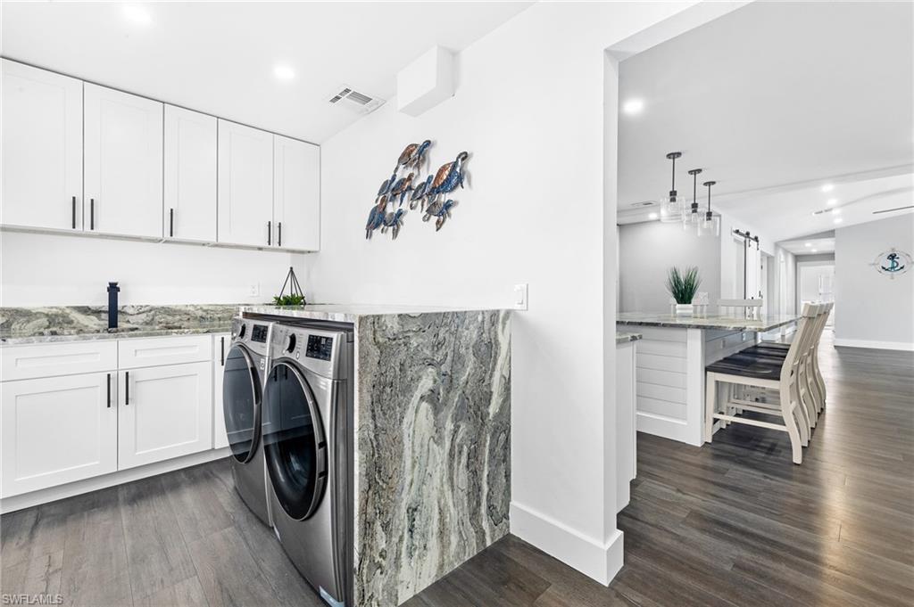 1330 Rock Road Naples, FL 34120 - Photo 13 of 37 Clothes washing area with visible vents, a sink, baseboards, washer and dryer, and dark wood-type flooring