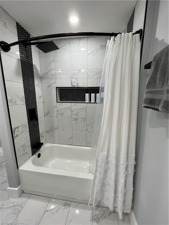 1330 Rock Road Naples, FL 34120 - Photo 20 of 37 Bathroom with baseboards, marble finish floor, and shower / bath combination with curtain