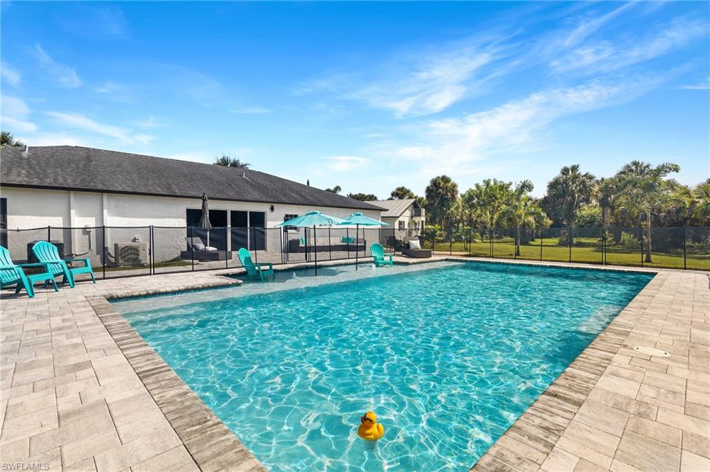 1330 Rock Road Naples, FL 34120 - Photo 2 of 37 View of pool featuring a fenced in pool, fence, and a patio