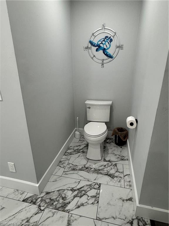 1330 Rock Road Naples, FL 34120 - Photo 21 of 37 Bathroom featuring toilet, baseboards, and marble finish floor