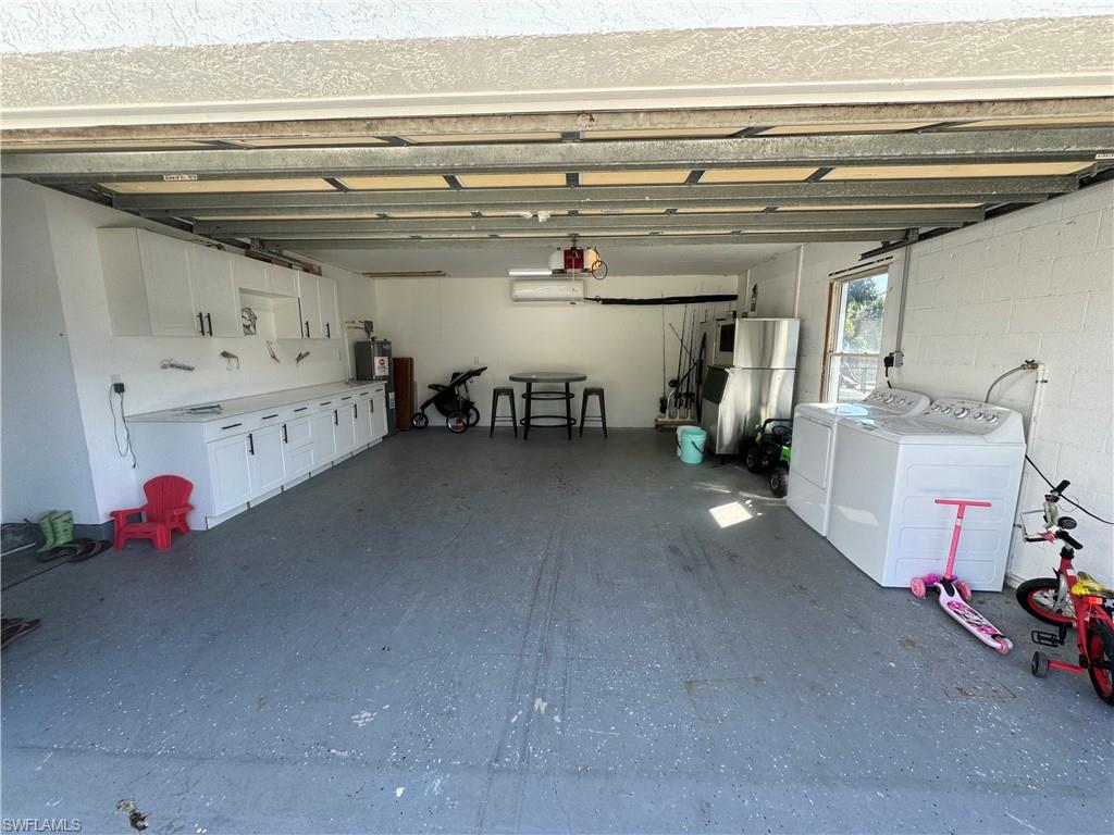 1330 Rock Road Naples, FL 34120 - Photo 25 of 37 Garage with freestanding refrigerator and washer and clothes dryer