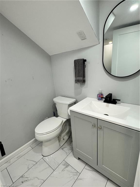 1330 Rock Road Naples, FL 34120 - Photo 35 of 37 Bathroom with toilet, baseboards, marble finish floor, and vanity