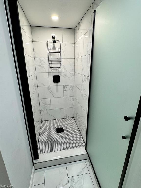1330 Rock Road Naples, FL 34120 - Photo 36 of 37 Full bathroom featuring baseboards, a stall shower, and marble finish floor
