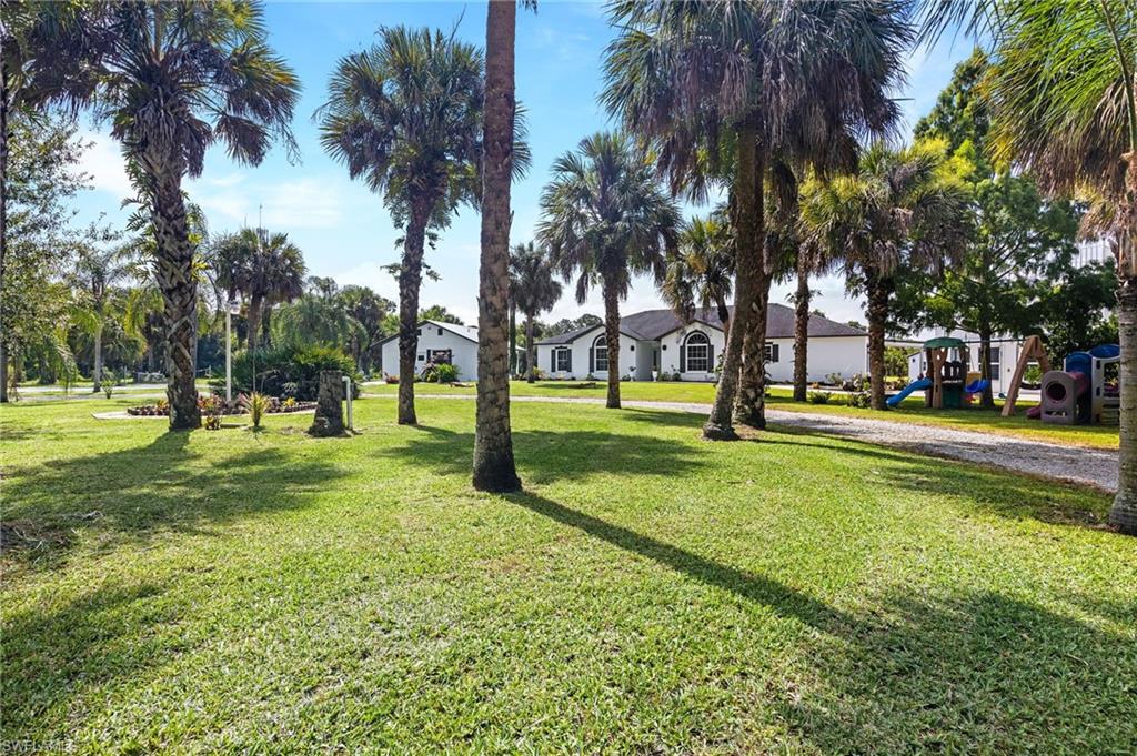 1330 Rock Road Naples, FL 34120 - Photo 6 of 37 View of property's community featuring a yard and a residential view