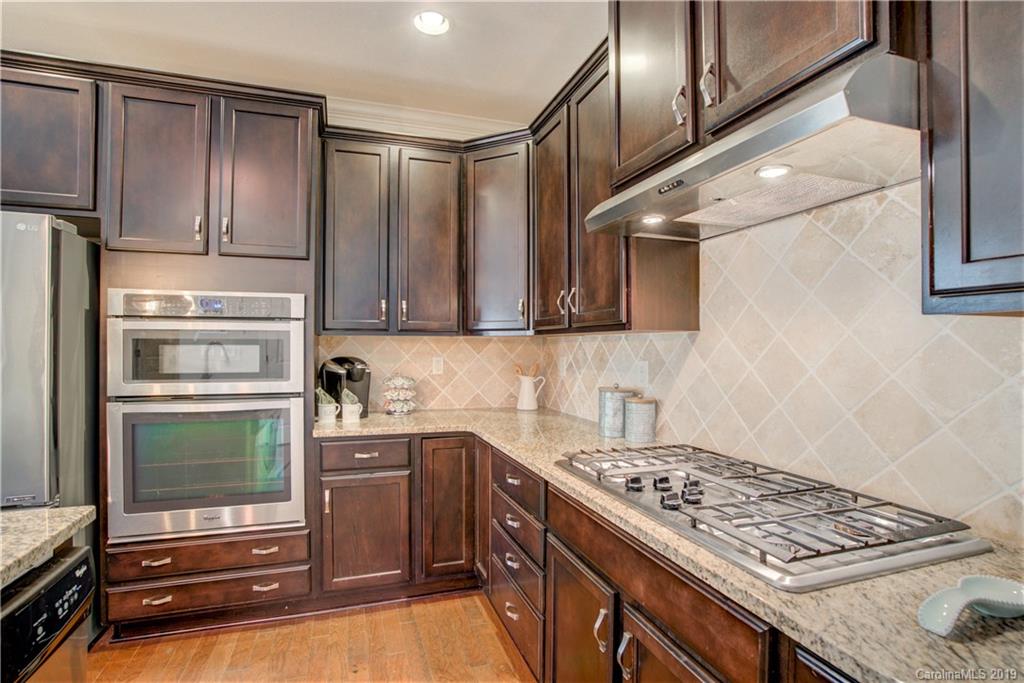 1633 Ridgehaven Road Waxhaw, NC 28173 - Photo 11 of 48 a kitchen with stainless steel appliances granite countertop a stove and a refrigerator