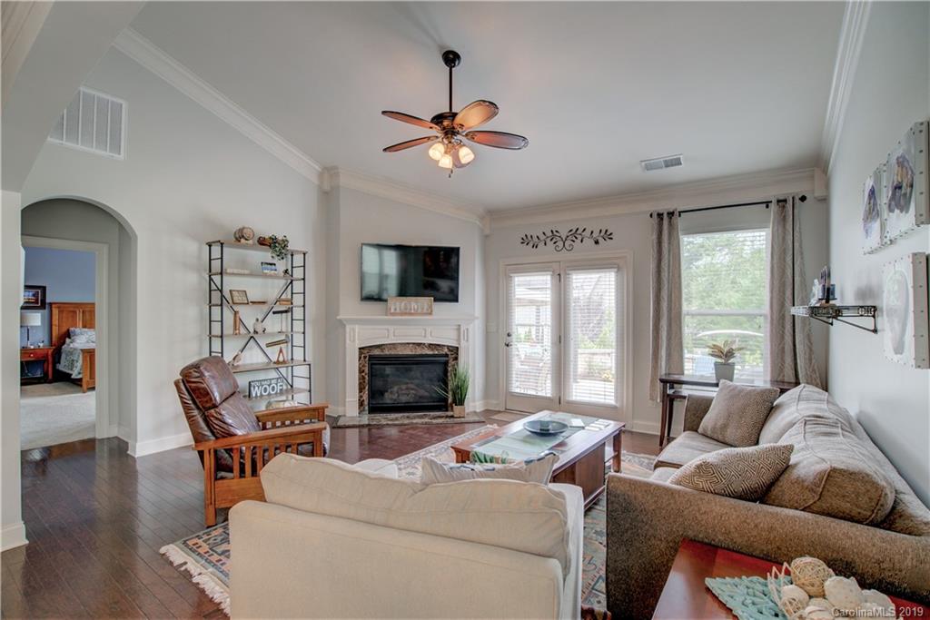 1633 Ridgehaven Road Waxhaw, NC 28173 - Photo 15 of 48 a living room with furniture a fireplace and a flat screen tv