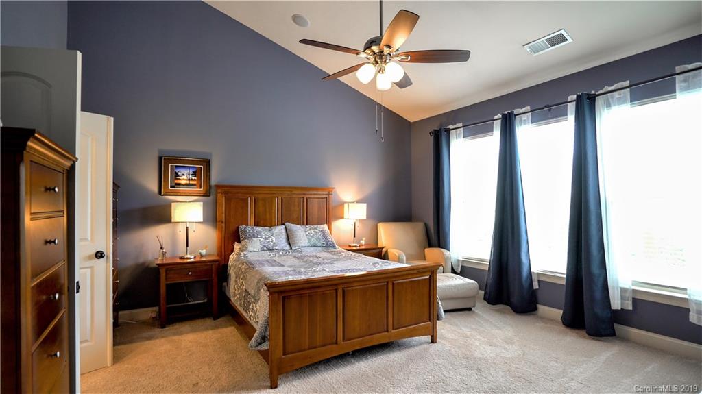 1633 Ridgehaven Road Waxhaw, NC 28173 - Photo 20 of 48 a bedroom with a bed and a chandelier