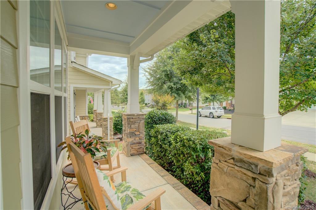 1633 Ridgehaven Road Waxhaw, NC 28173 - Photo 3 of 48 a view of a patio with table and chairs and potted plants