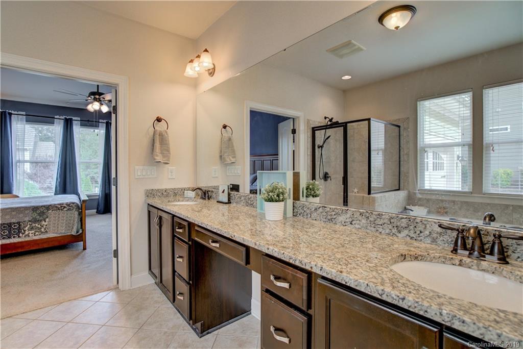 1633 Ridgehaven Road Waxhaw, NC 28173 - Photo 22 of 48 a bathroom with a granite countertop double vanity sink and a large mirror