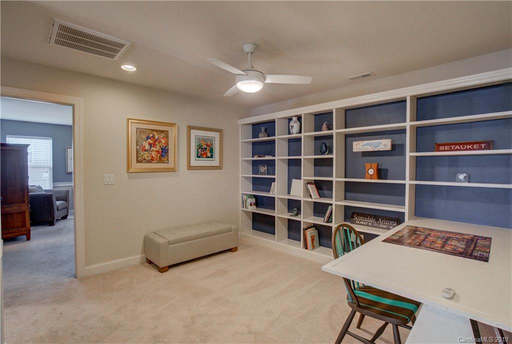 1633 Ridgehaven Road Waxhaw, NC 28173 - Photo 24 of 48 a living room with a furniture and a book shelf