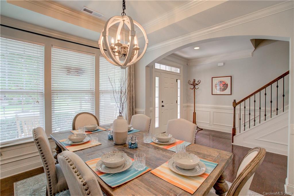 1633 Ridgehaven Road Waxhaw, NC 28173 - Photo 4 of 48 a view of a dining room with furniture a chandelier and wooden floor