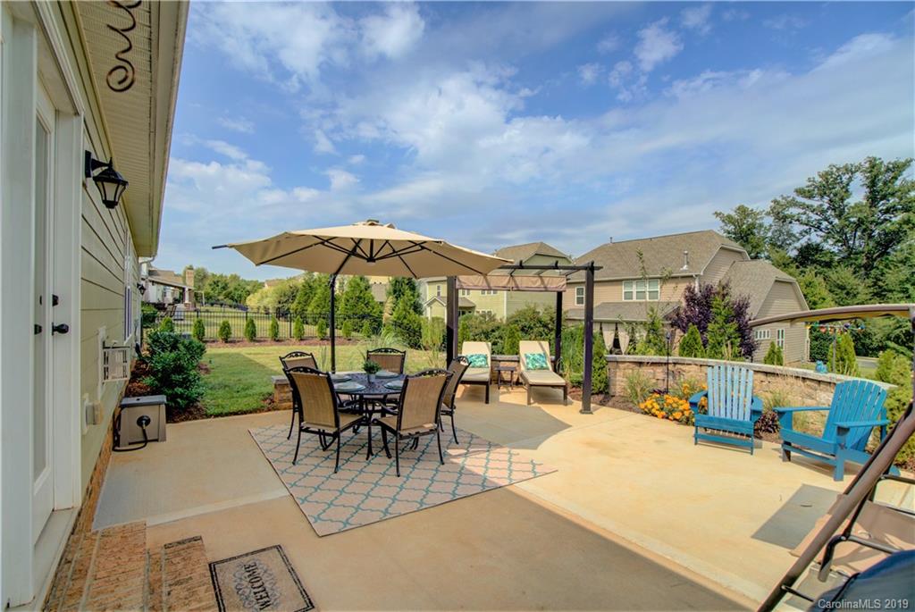 1633 Ridgehaven Road Waxhaw, NC 28173 - Photo 32 of 48 an outdoor space with furniture and umbrella