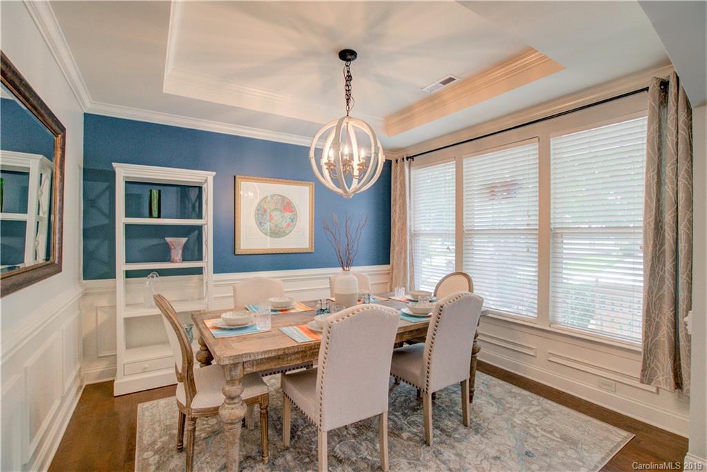 1633 Ridgehaven Road Waxhaw, NC 28173 - Photo 5 of 48 a dining room with furniture a chandelier and wooden floor