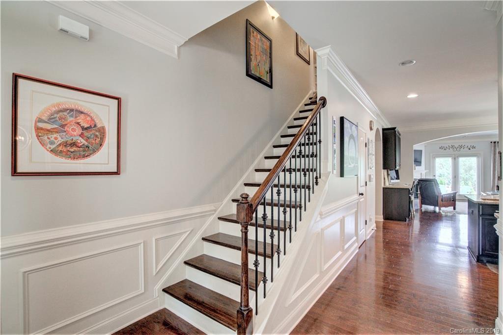 1633 Ridgehaven Road Waxhaw, NC 28173 - Photo 6 of 48 a view of staircase with lots of frames on wall and a view of entryway