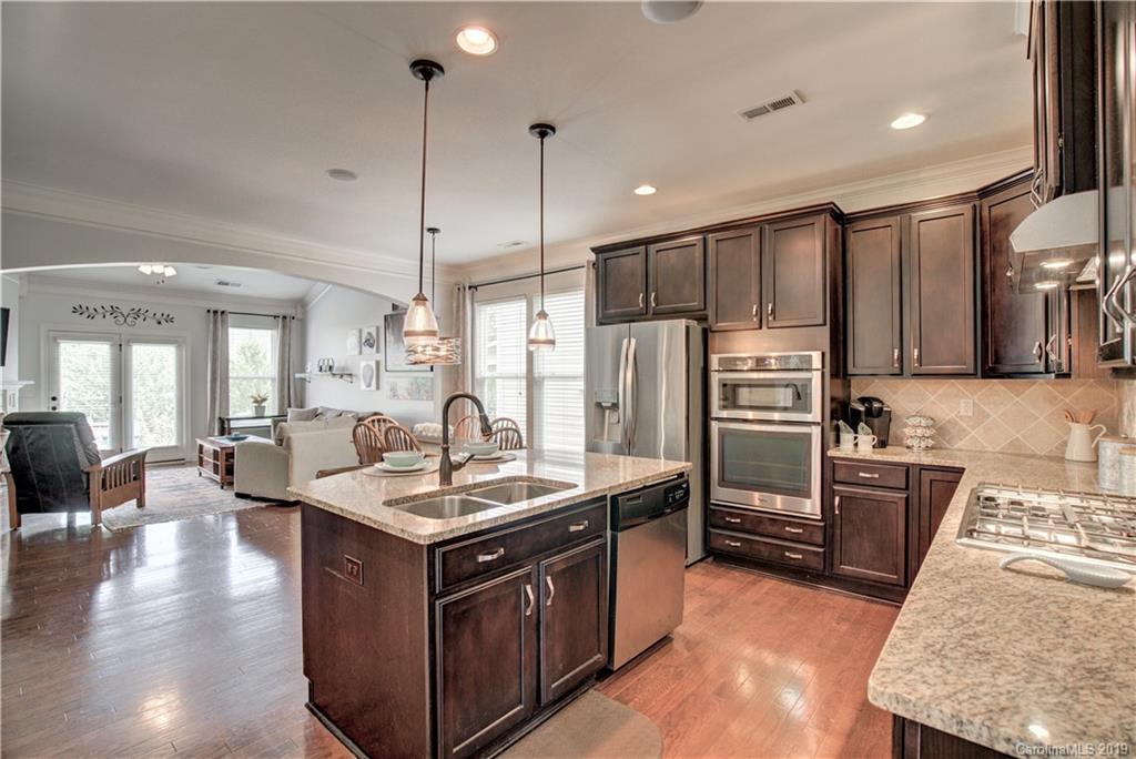 1633 Ridgehaven Road Waxhaw, NC 28173 - Photo 8 of 48 a kitchen with stainless steel appliances granite countertop a sink stove and refrigerator