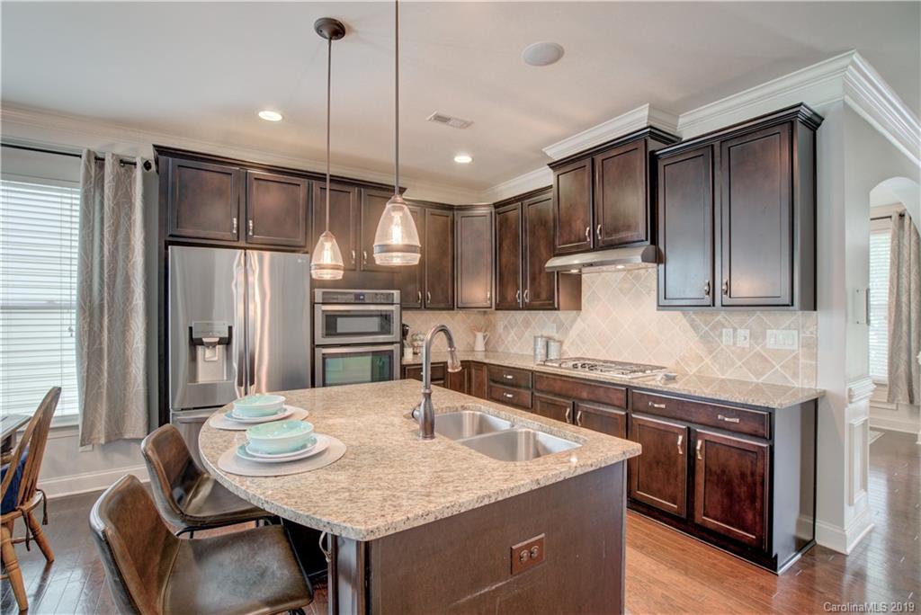 1633 Ridgehaven Road Waxhaw, NC 28173 - Photo 10 of 48 a kitchen with a table chairs refrigerator and microwave