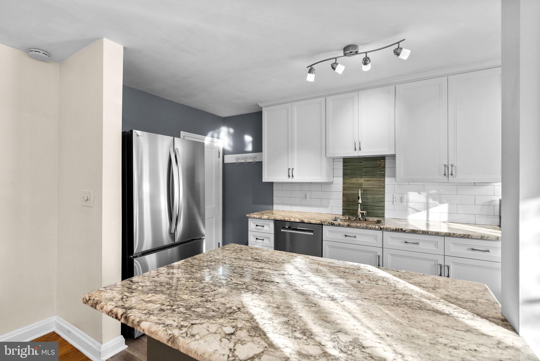 324 Stanmore Road Baltimore, MD 21212 - Photo 11 of 40 a kitchen with kitchen island sink refrigerator and cabinets