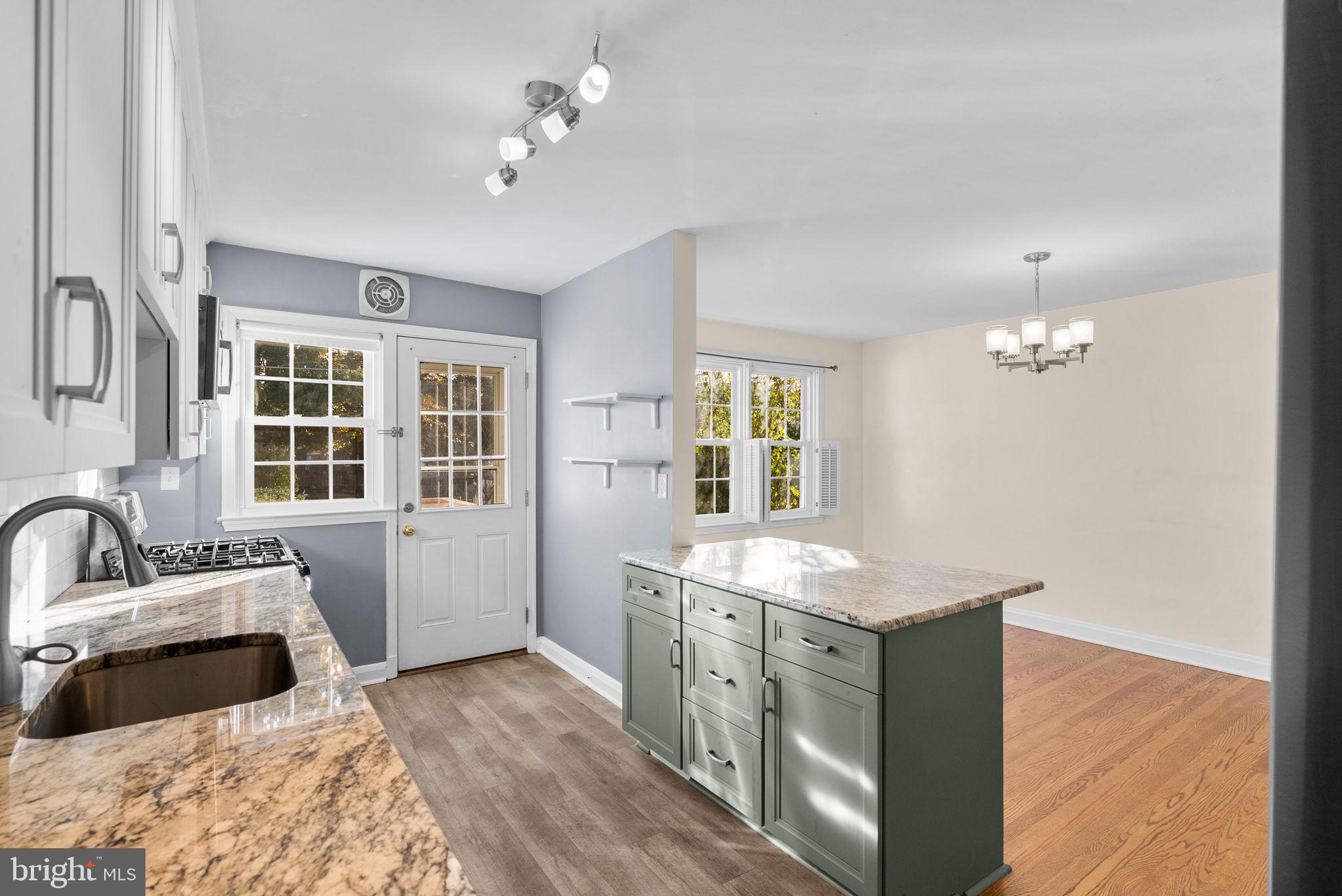 324 Stanmore Road Baltimore, MD 21212 - Photo 13 of 40 a kitchen with a stove a sink and a window