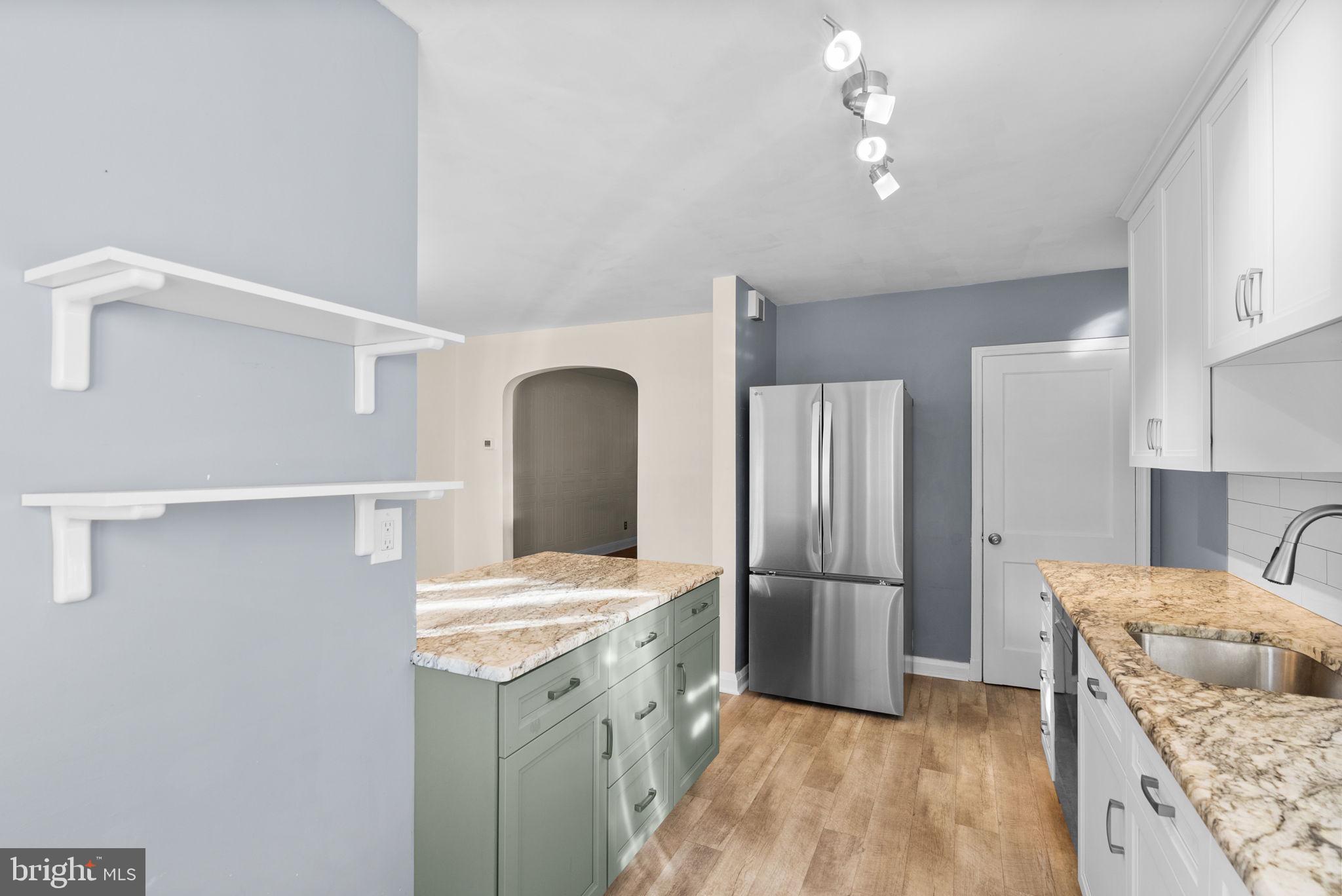 324 Stanmore Road Baltimore, MD 21212 - Photo 14 of 40 a kitchen with a refrigerator and a sink