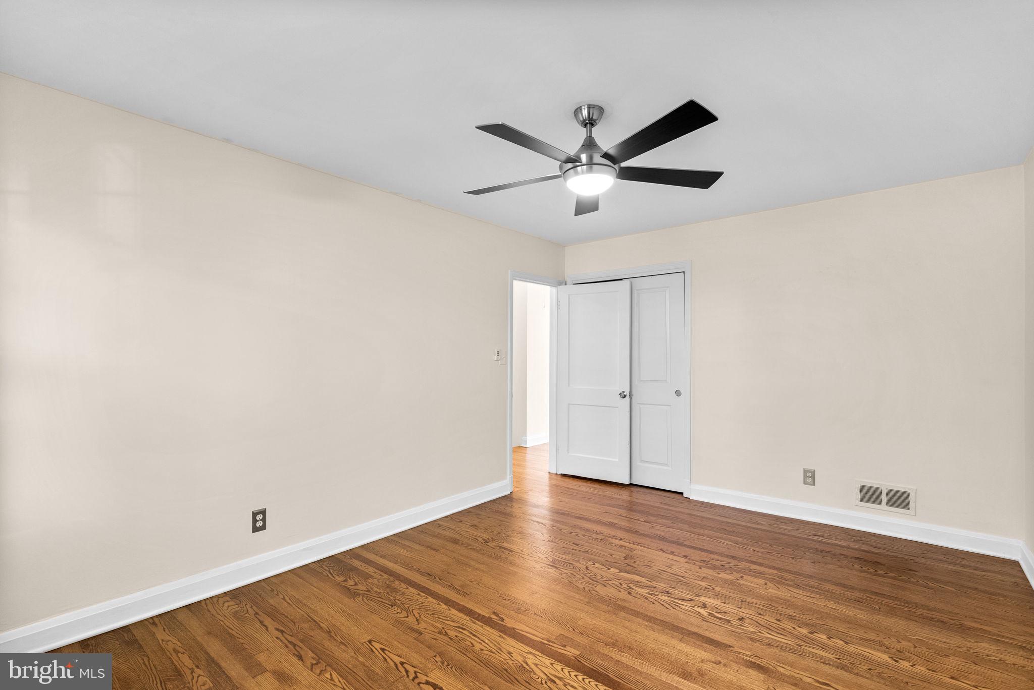 324 Stanmore Road Baltimore, MD 21212 - Photo 16 of 40 an empty room with wooden floor and windows